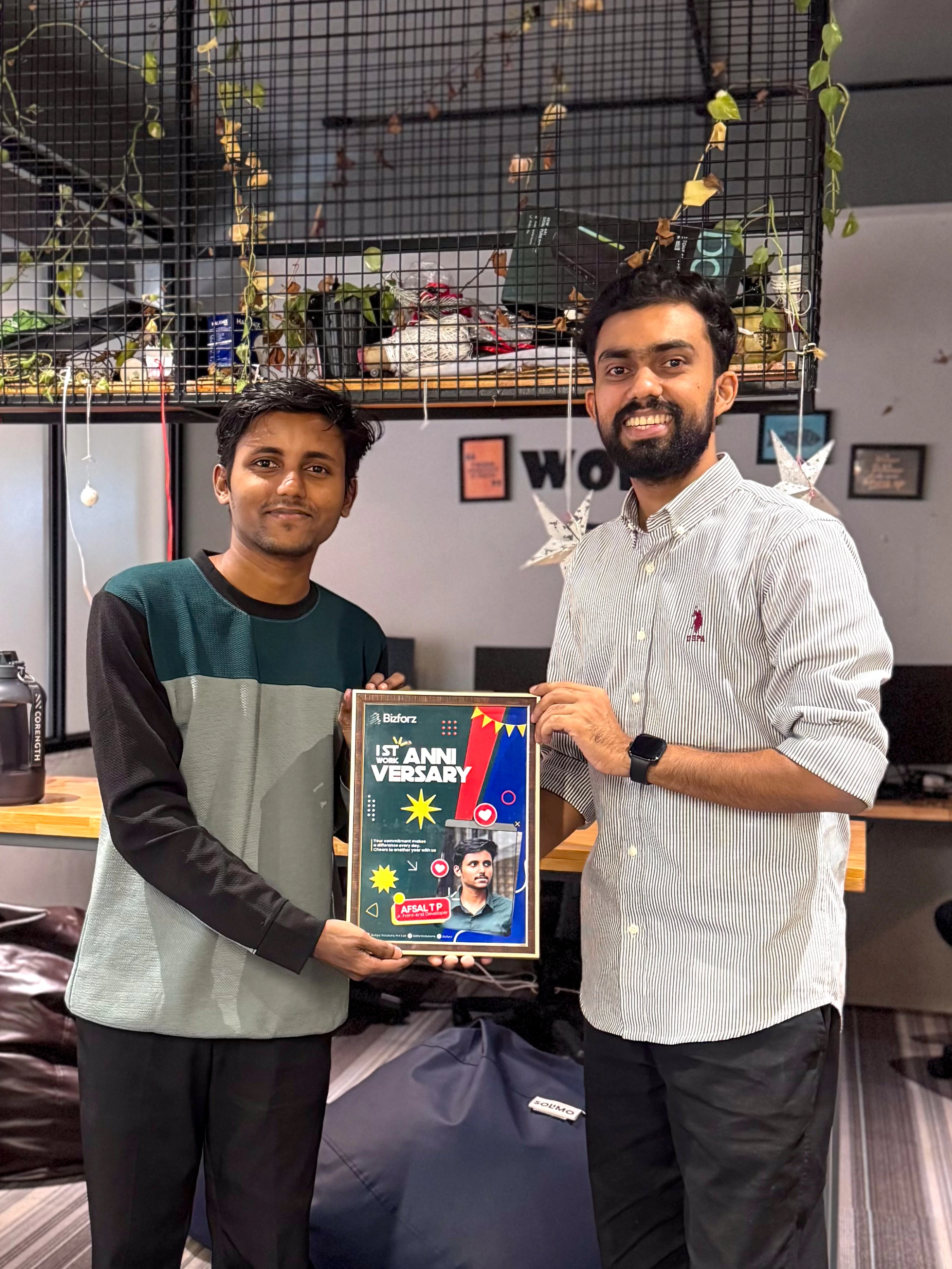 Muhammed Afsal receiving his one-year Bizforz work anniversary memento from his manager